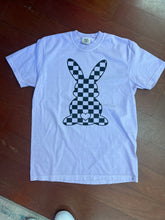 Load image into Gallery viewer, Lavender t-shirt with black checkered fish design on a wooden floor