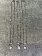 Load image into Gallery viewer, Three silver chains with charms on a textured gray surface