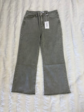 Load image into Gallery viewer, lt olive jeans with a tag on a textured white background