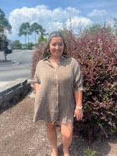 Load image into Gallery viewer, Woman standing outdoors near a bush with a clear sky in a brown gauze shirt dress