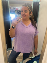 Load image into Gallery viewer, Woman wearing a purple top taking a mirror selfie.