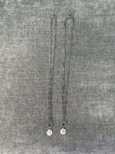 Load image into Gallery viewer, Two silver necklaces on a textured gray fabric background