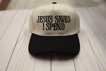 Load image into Gallery viewer, Cap with 'Jesus Saves I Spend' text on a wooden surface