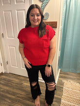 Load image into Gallery viewer, Woman wearing a red top and black ripped jeans standing in a room with a white door and light blue curtain.