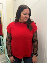 Load image into Gallery viewer, Woman wearing a red top with sheer sleeves in a room.