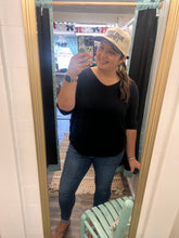 Load image into Gallery viewer, Person taking a mirror selfie wearing a black top and blue jeans indoors wearing a hat