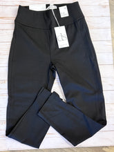 Load image into Gallery viewer, Folded black pants with tags on a light wooden surface