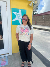 Load image into Gallery viewer, Woman wearing a 'Teacher Teacher' shirt in front of a yellow building with a sign.