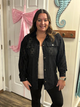 Load image into Gallery viewer, Woman wearing a black lace shacket standing in a room with a pink bow and decorative wall piece.