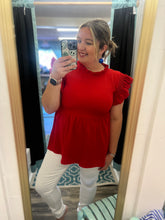 Load image into Gallery viewer, Woman taking a mirror selfie wearing a red top and white pants.