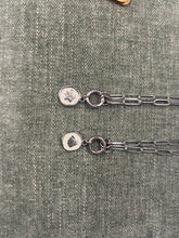 Load image into Gallery viewer, Two silver necklaces with pendants on a textured gray surface