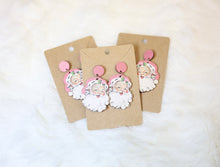 Load image into Gallery viewer, Set of Santa Claus-themed earrings on brown cardstock with pink accents.
