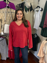 Load image into Gallery viewer, Woman wearing a red sweater in a clothing store
