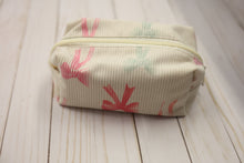 Load image into Gallery viewer, cream cosmetic pouch with bows on a wooden surface
