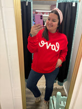 Load image into Gallery viewer, Person wearing a red sweatshirt with white text, taking a mirror selfie.
