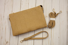 Load image into Gallery viewer, Beige textured handbag with matching strap on a light wooden surface
